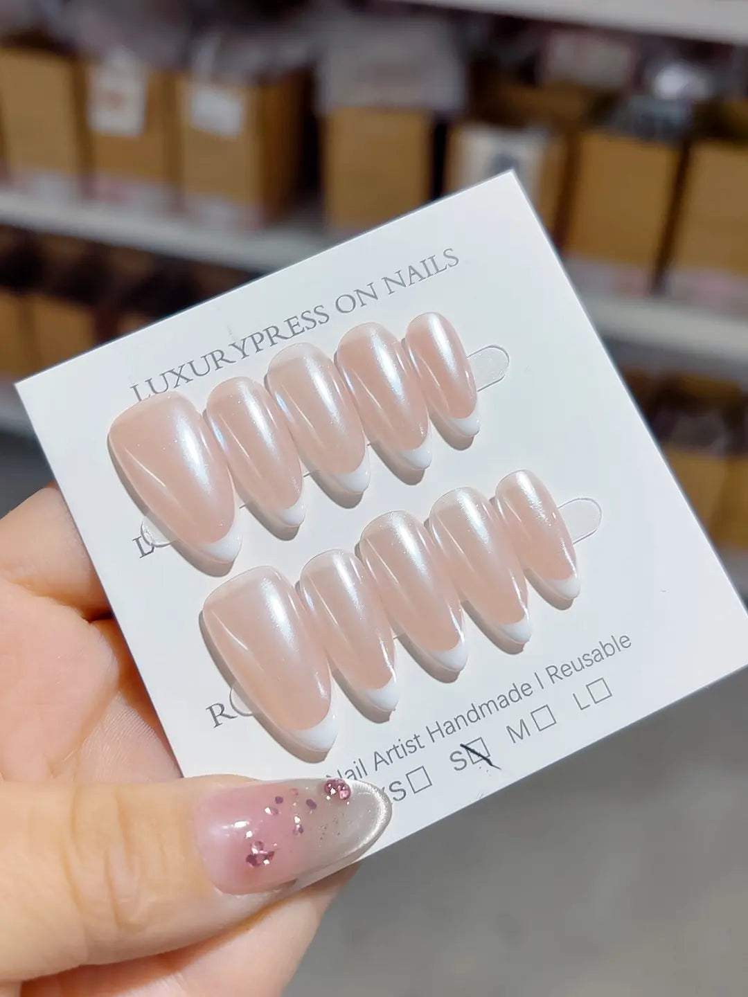 handmade press on nails set, close-up of medium almond nude base and clean french lines