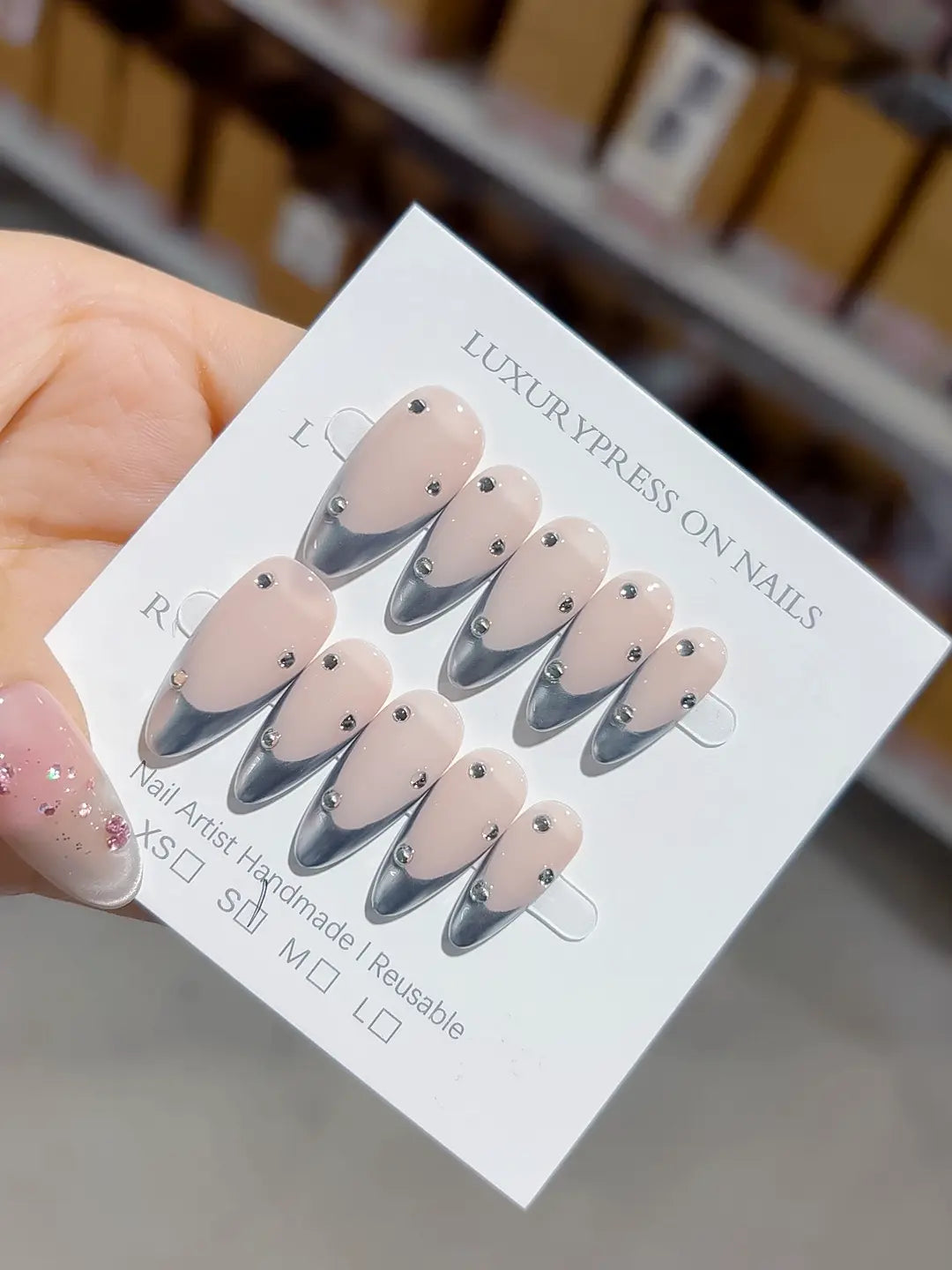 handmade press on nails set, close-up of nude chrome french with evenly placed rhinestone accents