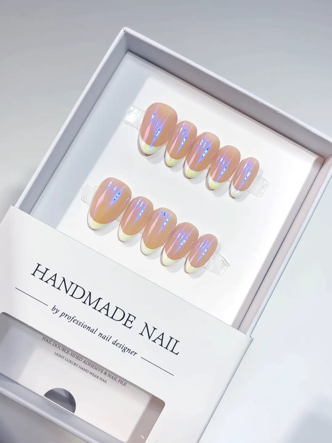 Close-up of glazed chrome finish on short almond purple aurora handmade press on nails.
