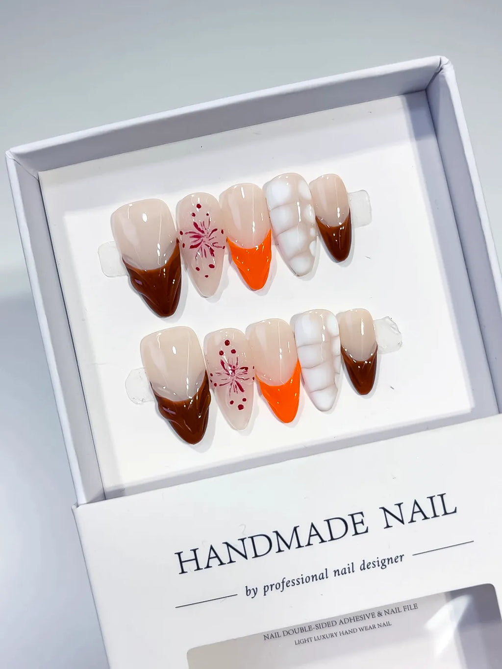 Nude Brown Orange White French tip Flower 3D press on nails angled view
