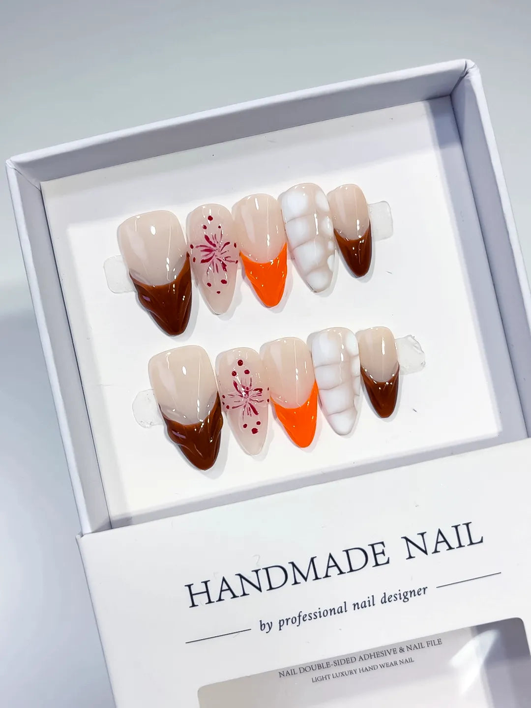 Nude Brown Orange White French tip Flower 3D press on nails angled view