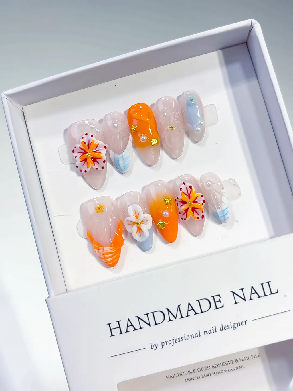 Nude Orange White Blue Abstract Flower Shell Rhinestone press on nails angled view