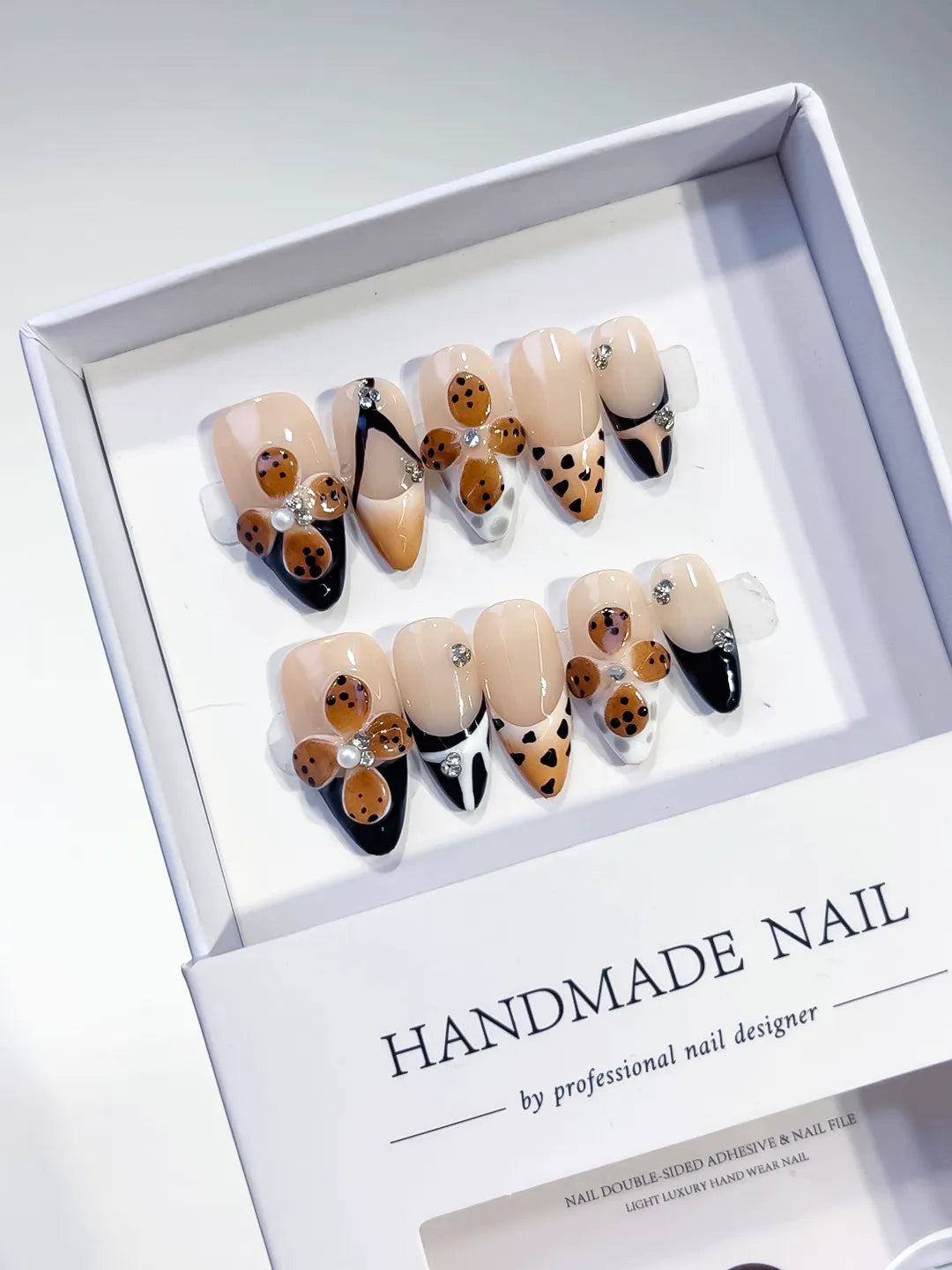 Nude Black Brown White French tip Cookie Animal Print Rhinestone press on nails angled view