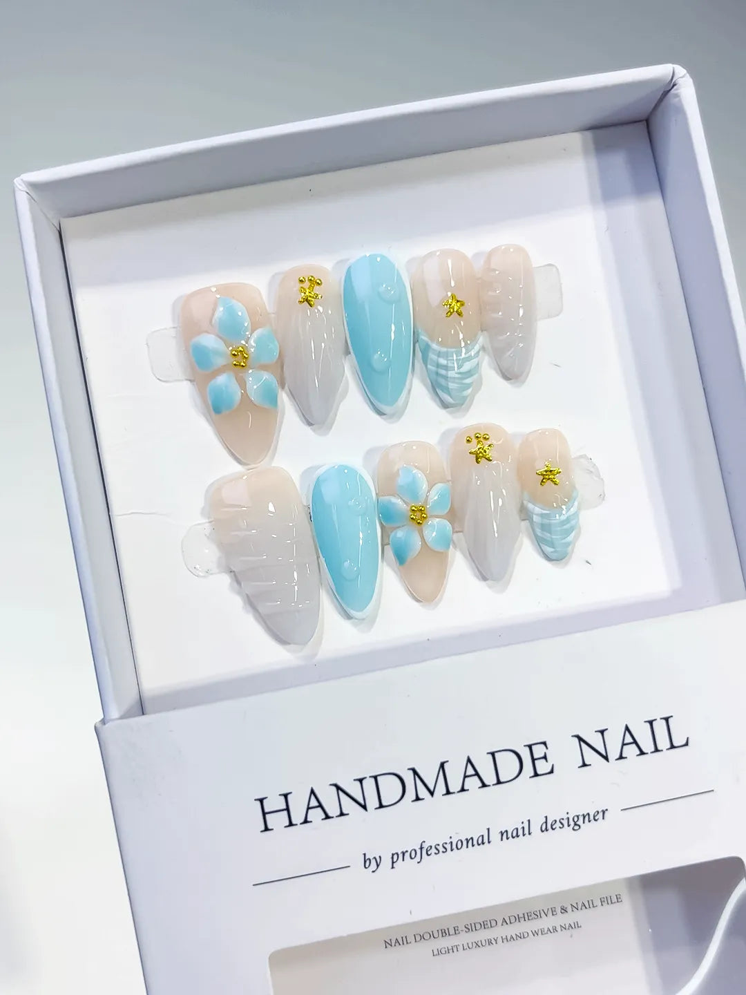 Nude Blue White French tip Flower Shell Star press on nails angled view