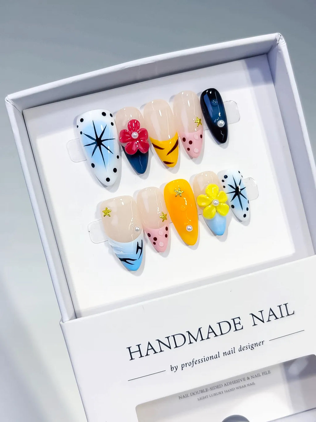 Blue Yellow Pink White Black Abstract Flower Star Dot Pattern press on nails angled view