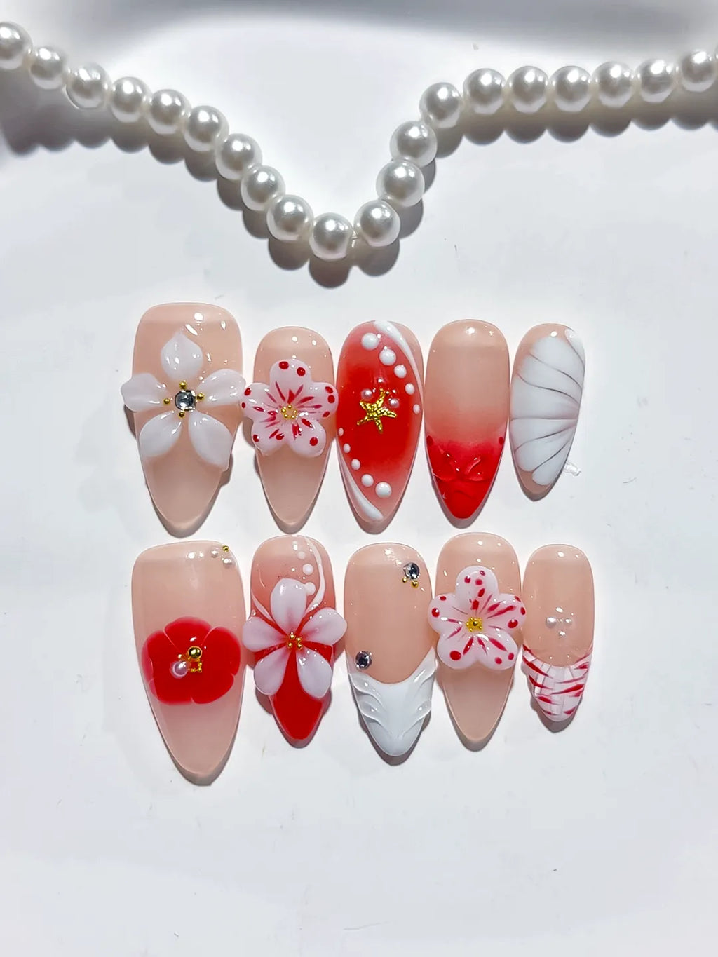 Nude Red White Abstract Flower Star Shell press on nails angled view