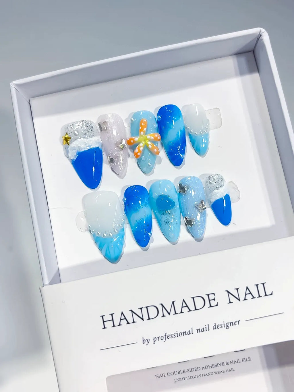 Blue White Silver Glitter Flower Star Shell press on nails angled view