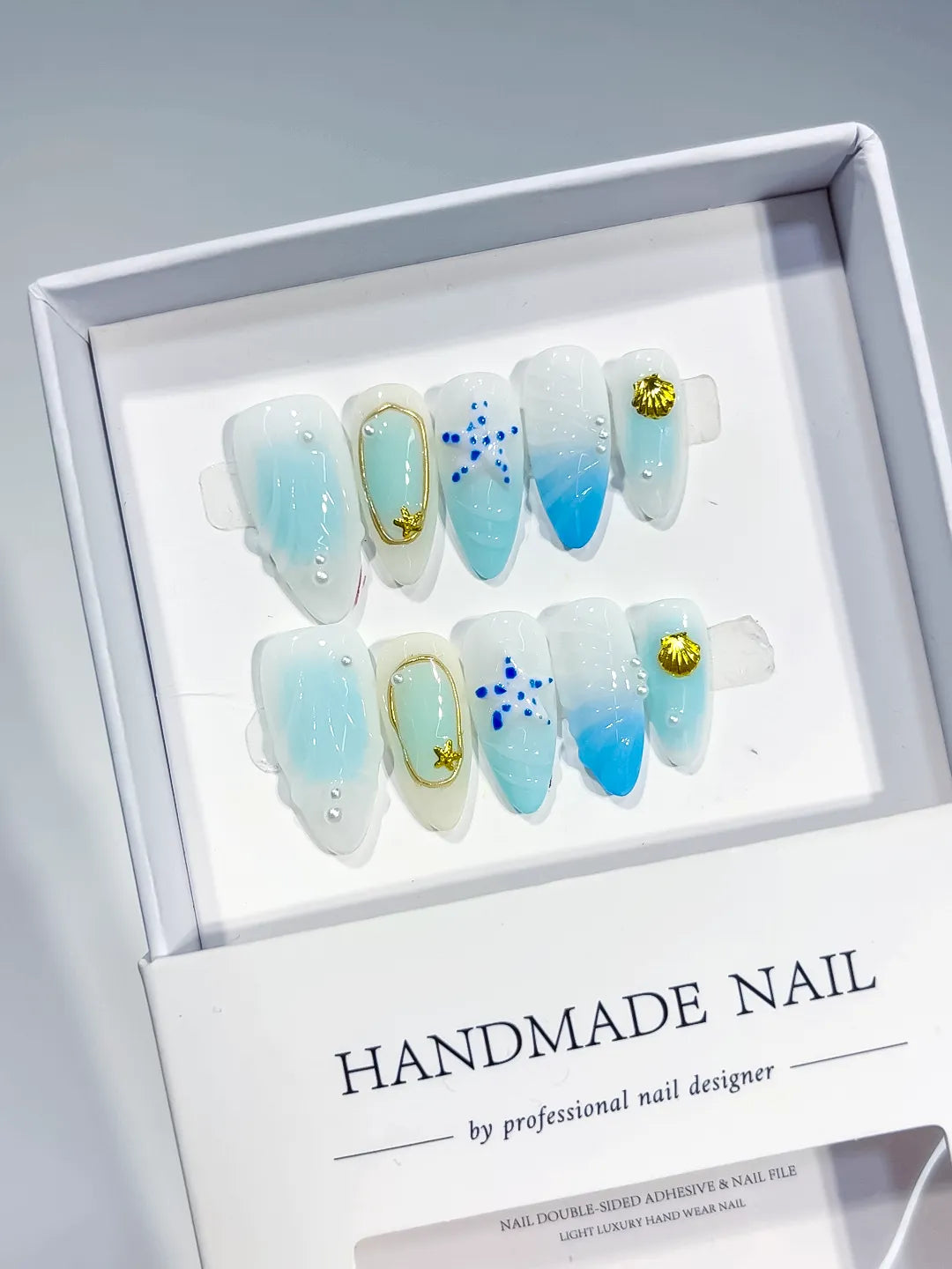 White Blue Gold Ombre Star Shell Metallic Charm press on nails angled view