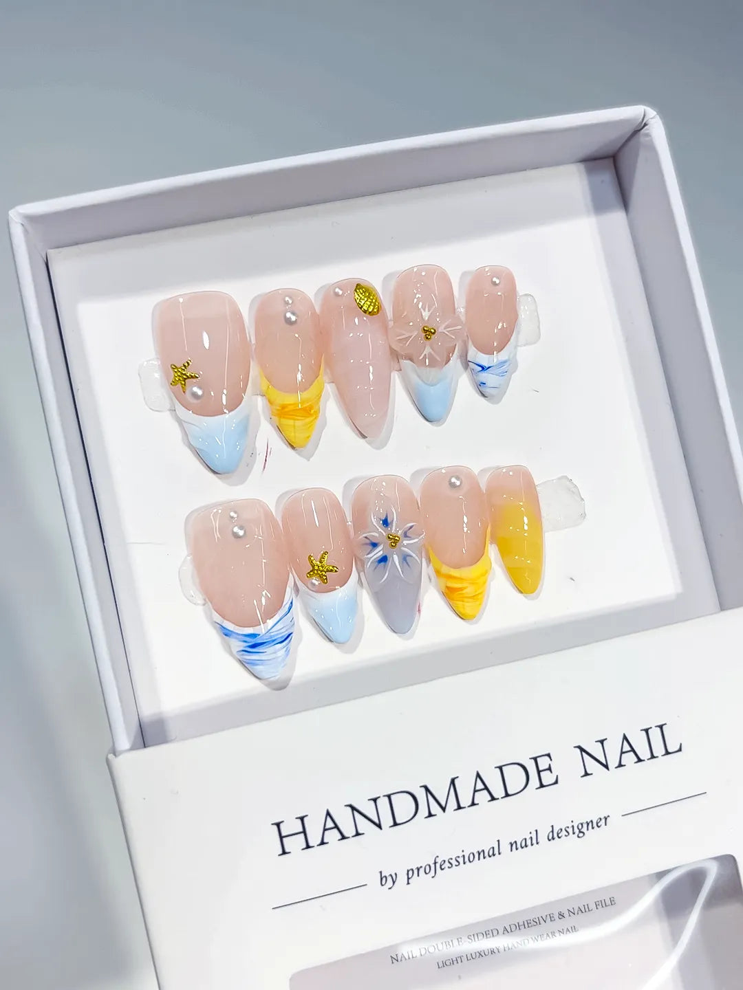 Nude Blue Yellow White French tip Flower Star Shell press on nails angled view