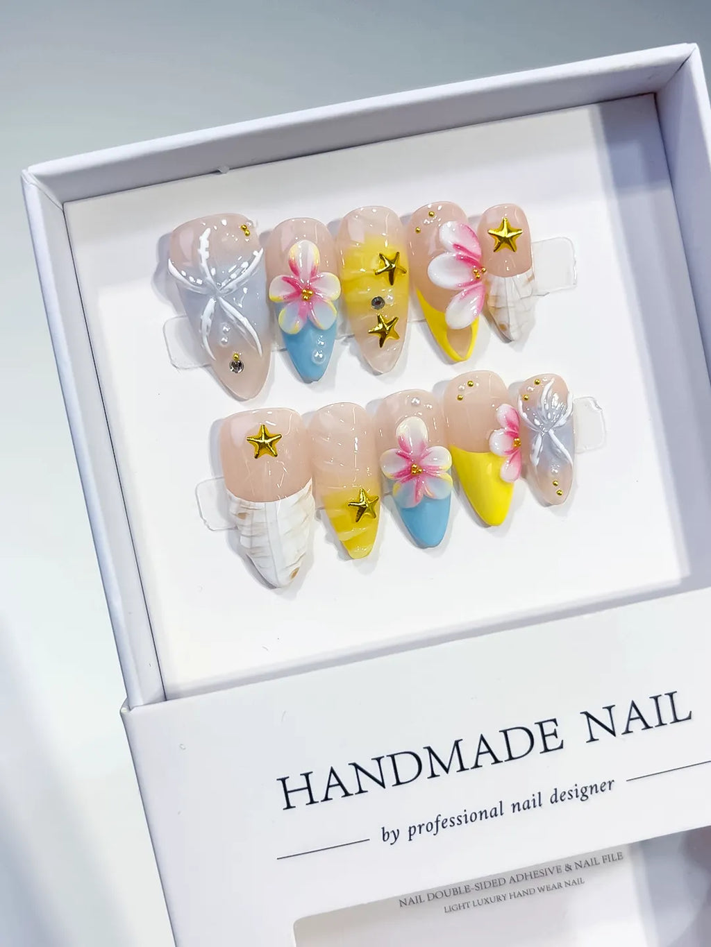 Nude White Blue Yellow French tip Flower Bow Star press on nails angled view