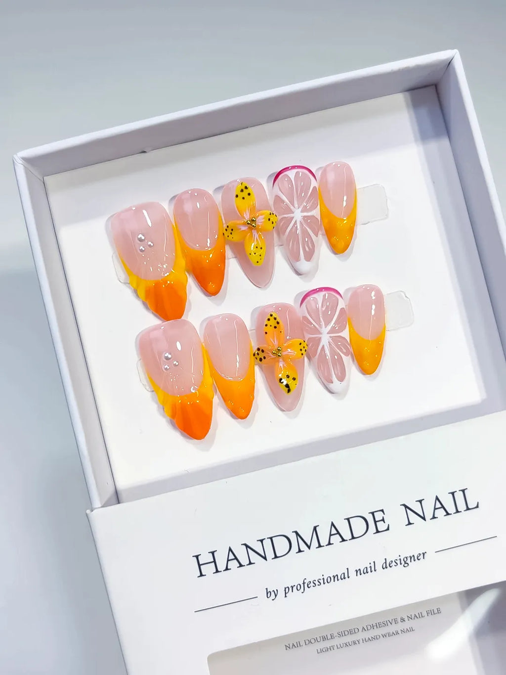 Nude Orange Pink French tip Flower Fruit press on nails angled view