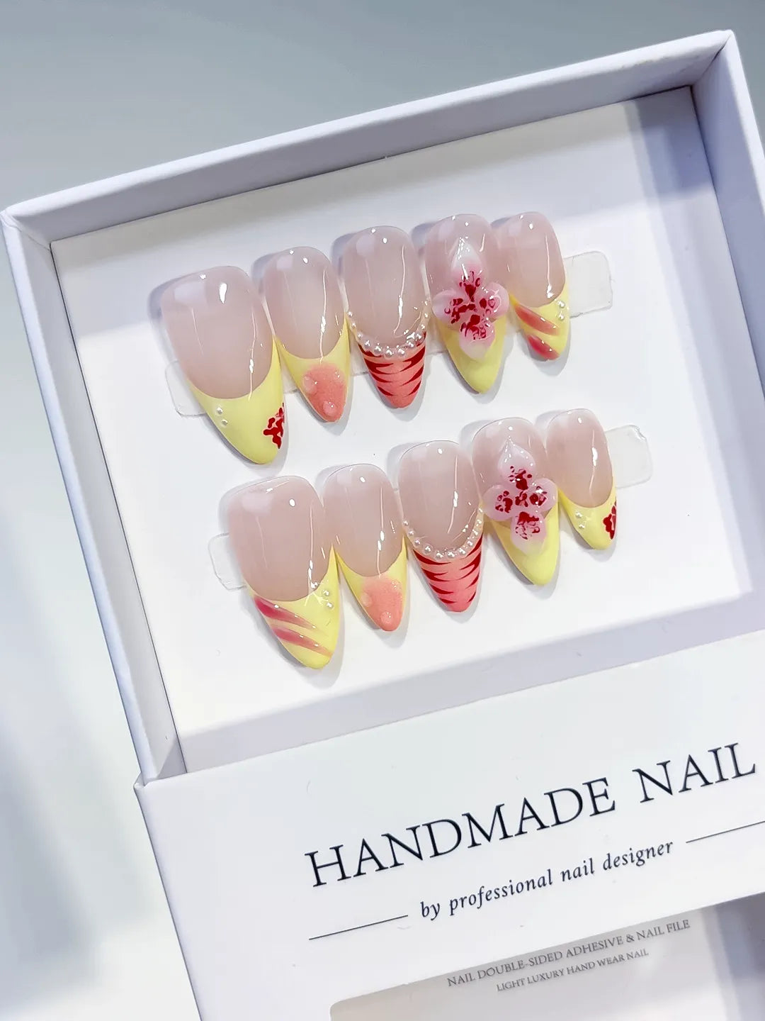 Nude Yellow Pink French tip Flower Pearl Stripe press on nails angled view