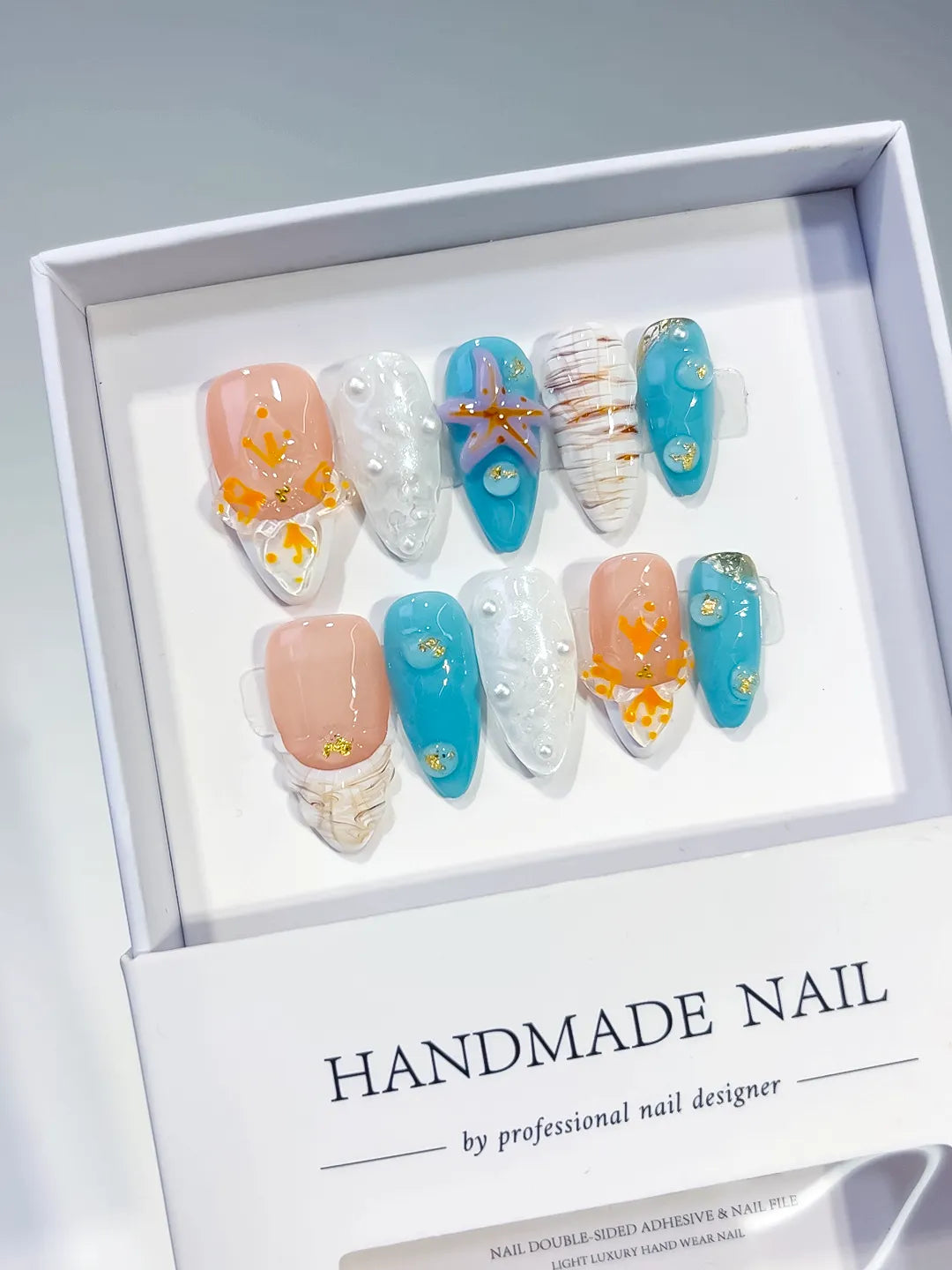 Nude Blue White Orange Gold Abstract Starfish Shell Pearl press on nails angled view