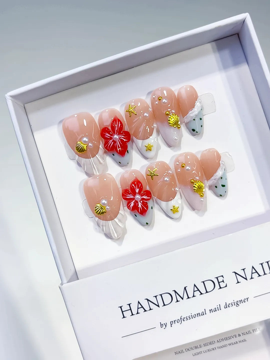 Nude White Red Gold French tip Flower Star Shell press on nails angled view