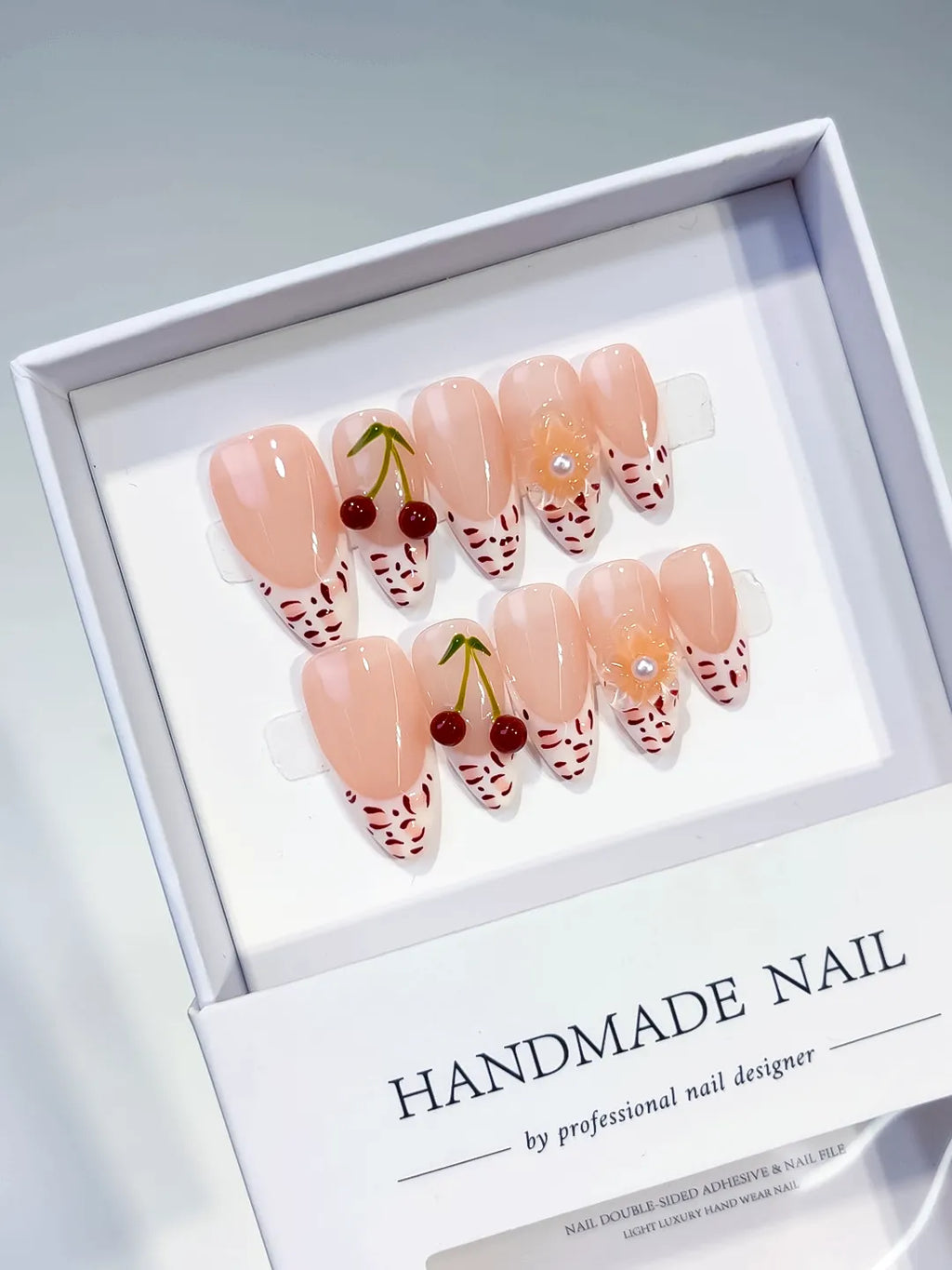Nude White Red French tip Cherry Animal Print press on nails angled view