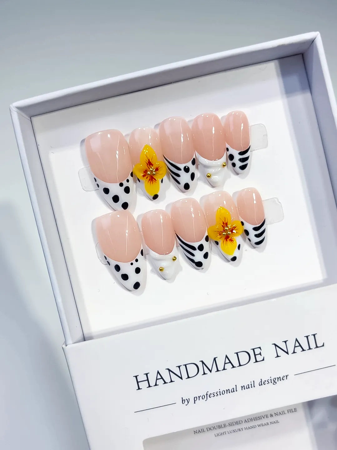 Nude Black White Yellow French tip Flower Dot Pattern press on nails angled view