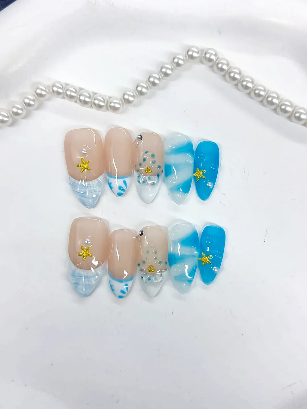 Nude Blue White French tip Star Rhinestone Shell press on nails detail view