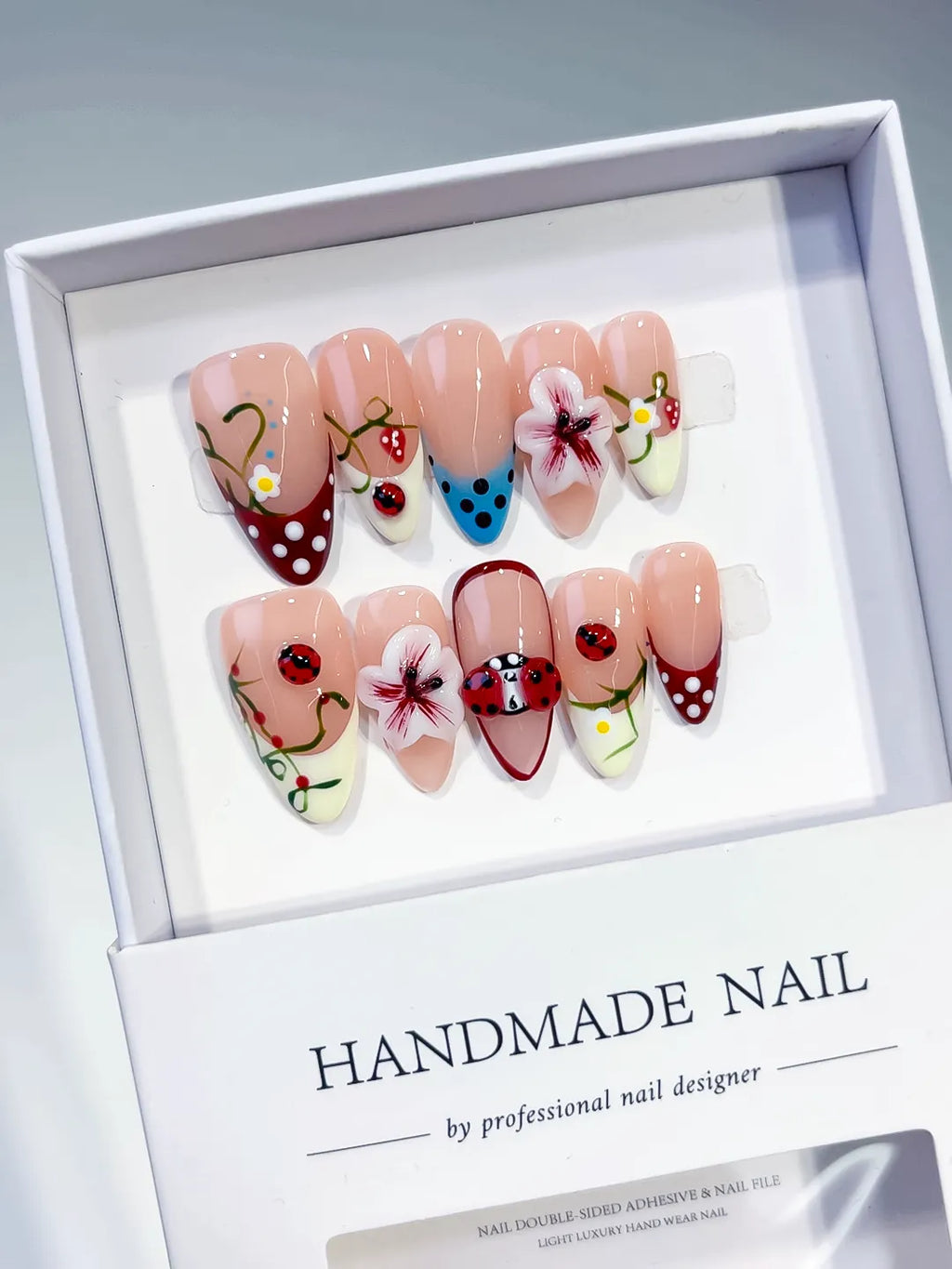 Nude Red White Blue Abstract Flower Ladybug Strawberry press on nails angled view