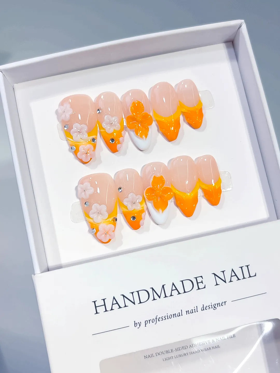 Nude Orange White French tip Flower Rhinestone press on nails angled view