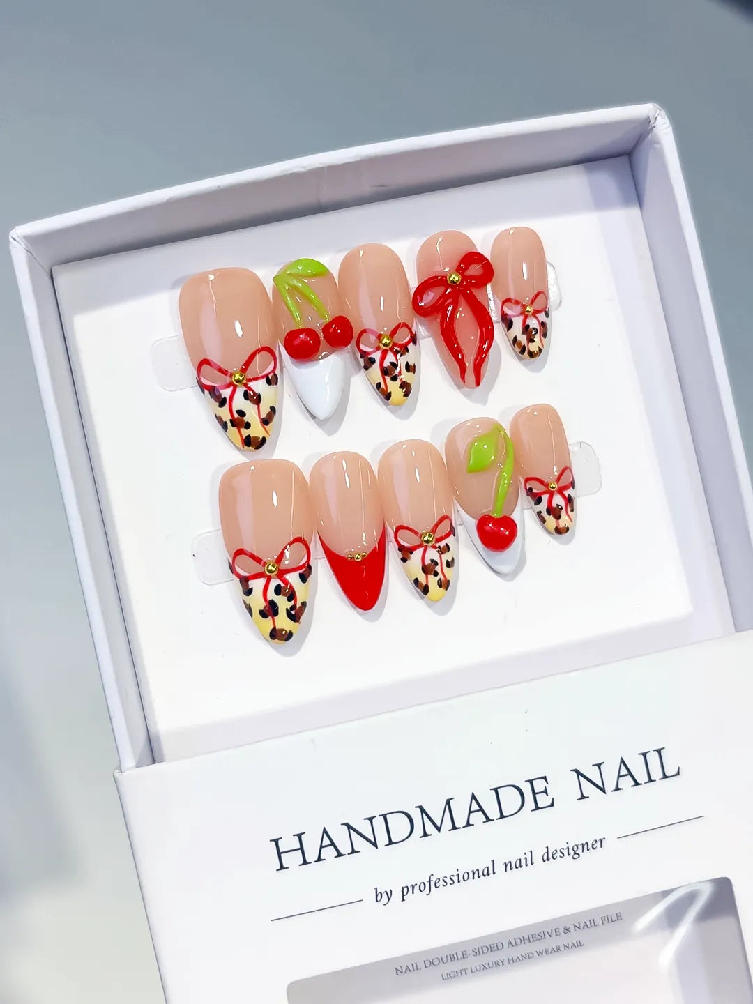 Nude Red White Abstract Bow Cherry Animal Print press on nails angled view