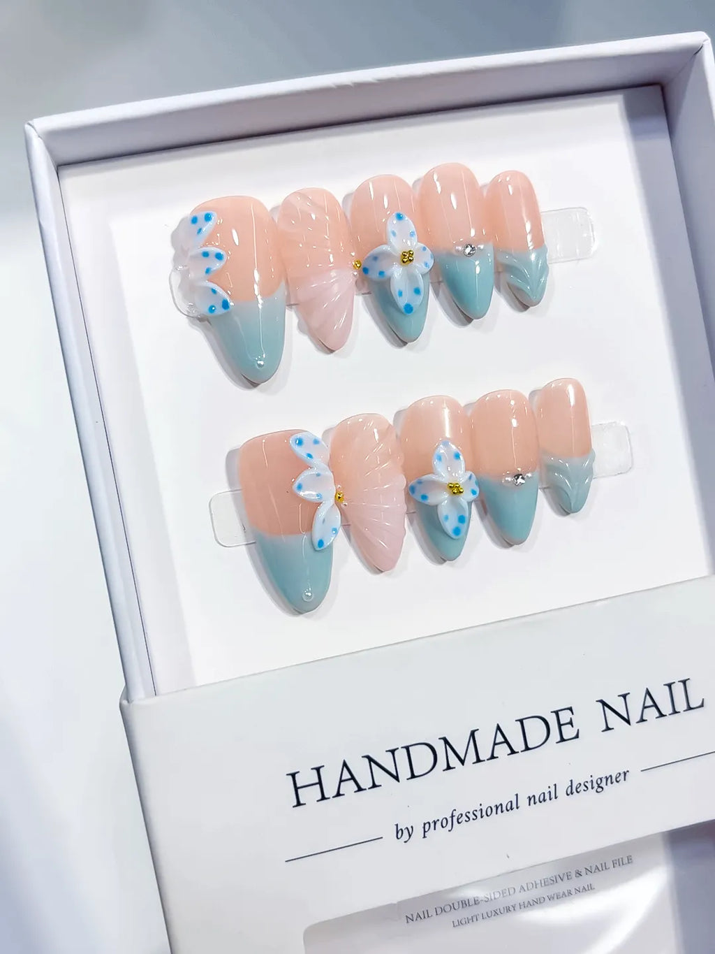 Nude Blue White French tip Flower Bow Shell press on nails angled view