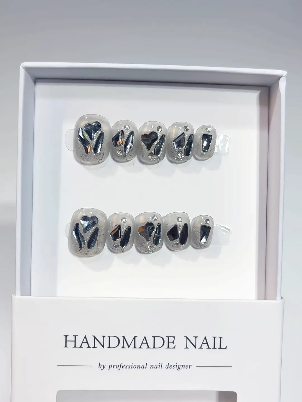 Full set of grey silver handmade press on nails featuring explosive bling rhinestones with a professional finish.