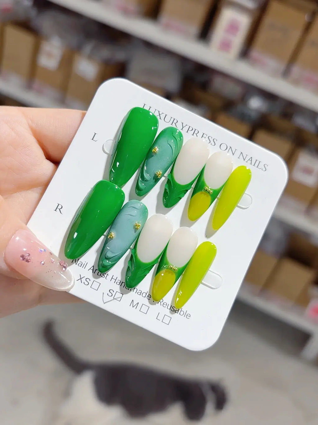 Handmade press on nails green swirl and metallic bead details angled set display