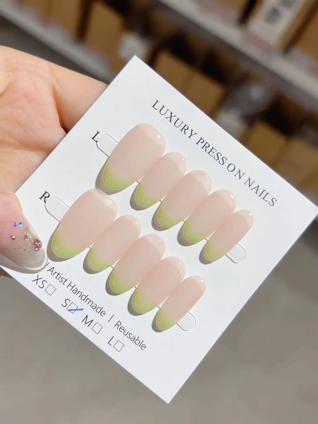 Handmade press on nails medium almond nude French with green tips, full set display