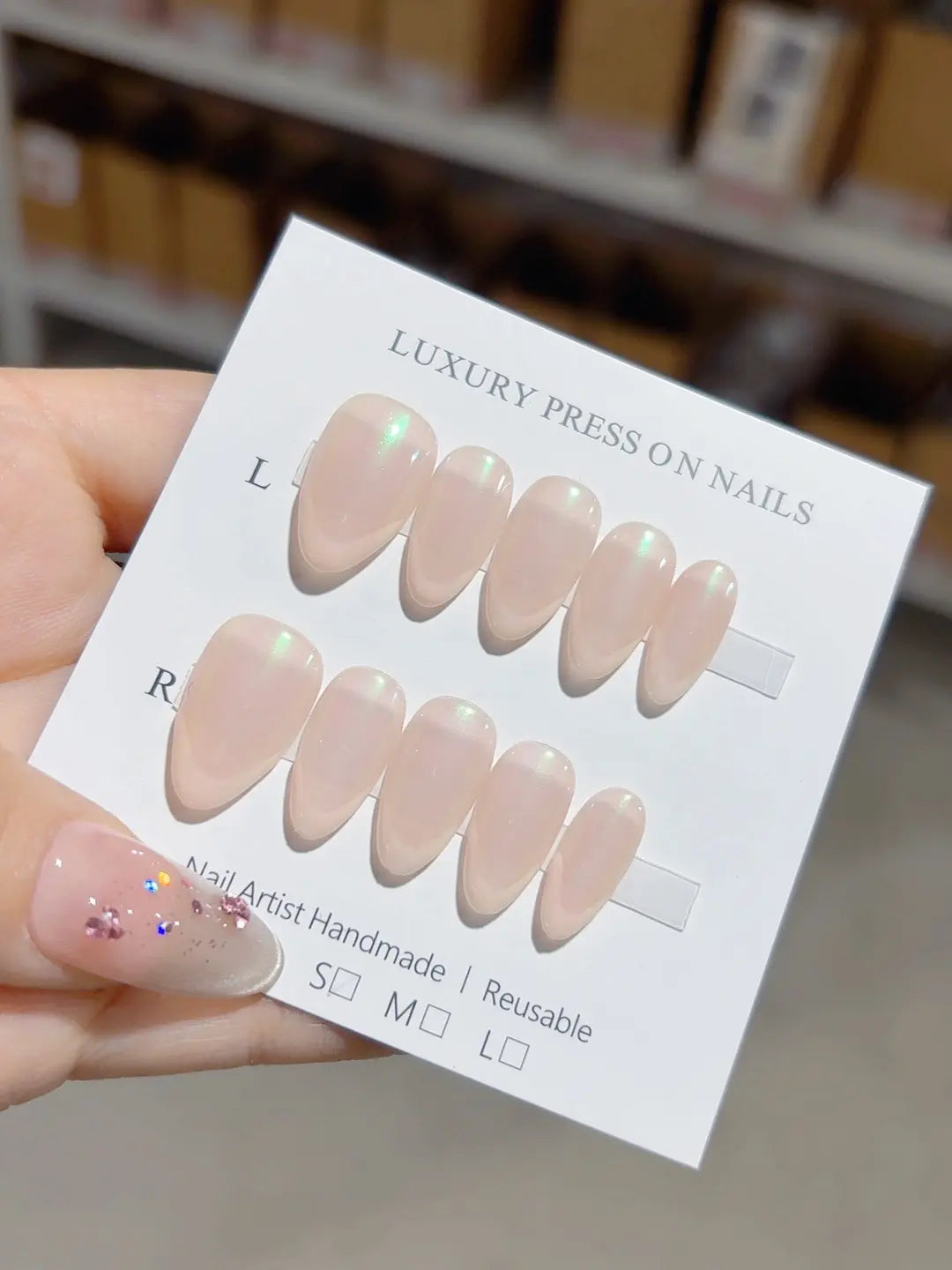 Handmade press on nails nude almond with green aurora shimmer, centerpiece view