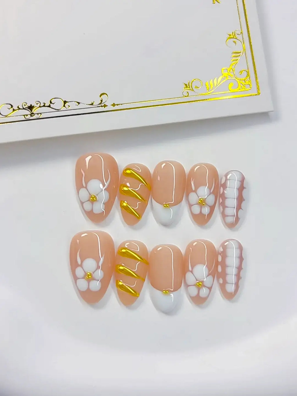Handmade press on nails short almond nude with gold swirl accents detail