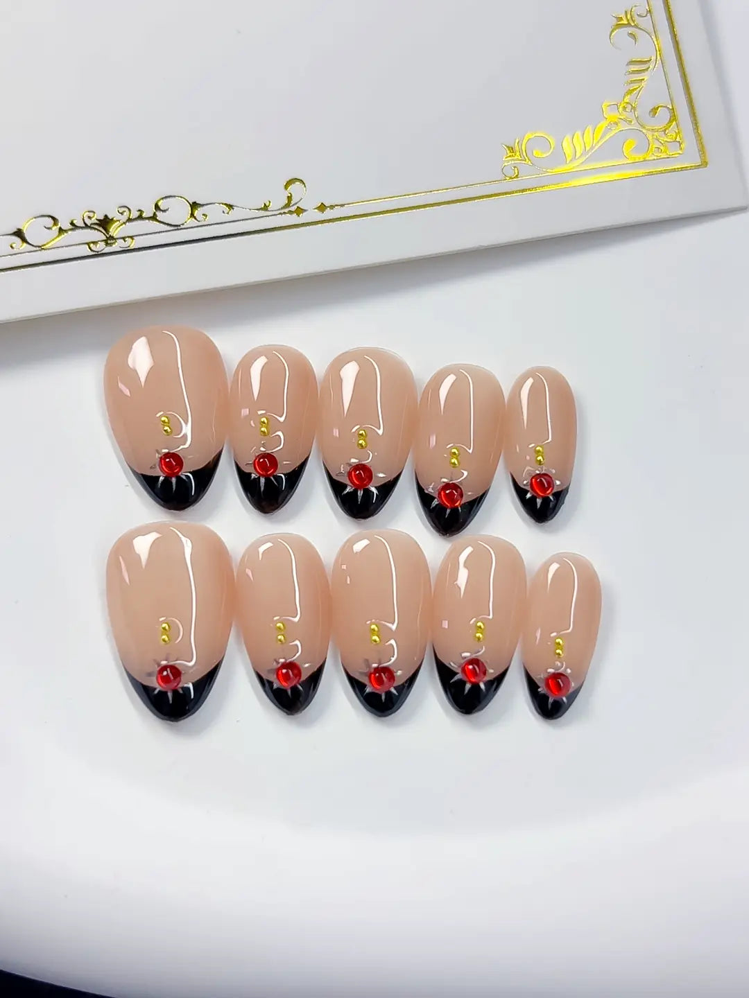 Handmade press on nails short almond nude with luxury rose accent close-up