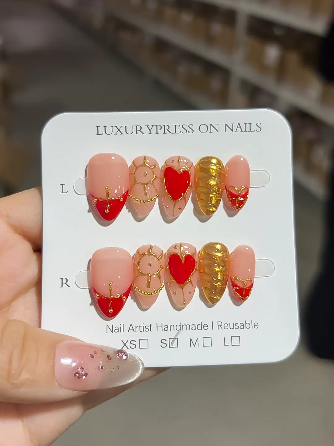 Handmade press on nails short almond nude with red hearts and gold glitter centerpiece