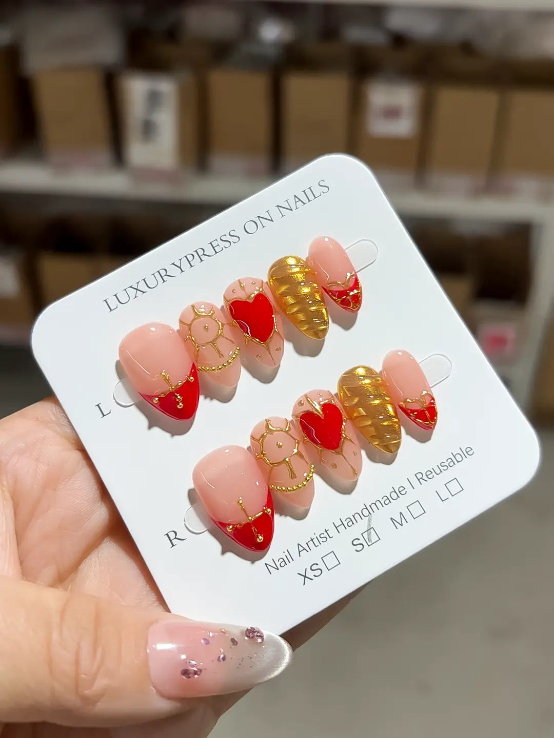 Handmade press on nails short almond red and gold mix with heart details close-up