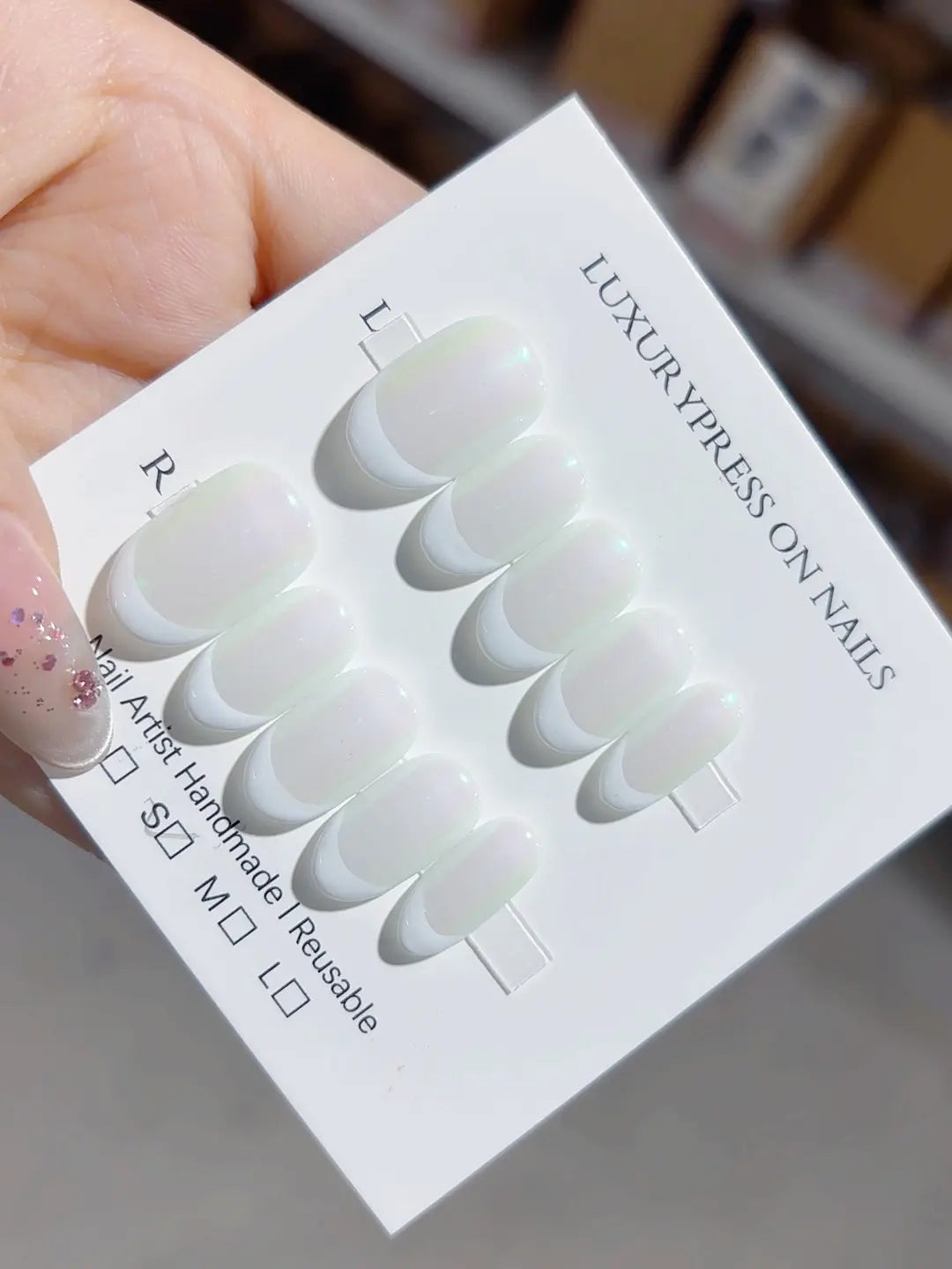 Handmade press on nails short oval French design with soft green glow, side view