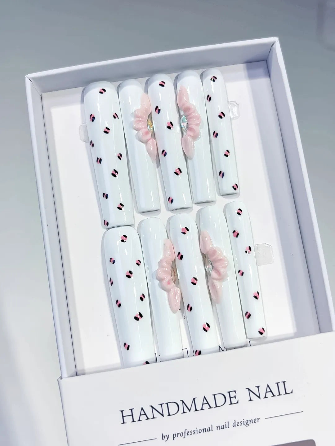 White Pink Black Abstract Bow 3D press on nails angled view