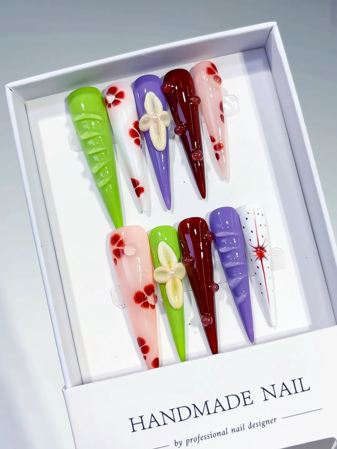 Green White Purple Red Pink Abstract Flower Bow 3D press on nails angled view