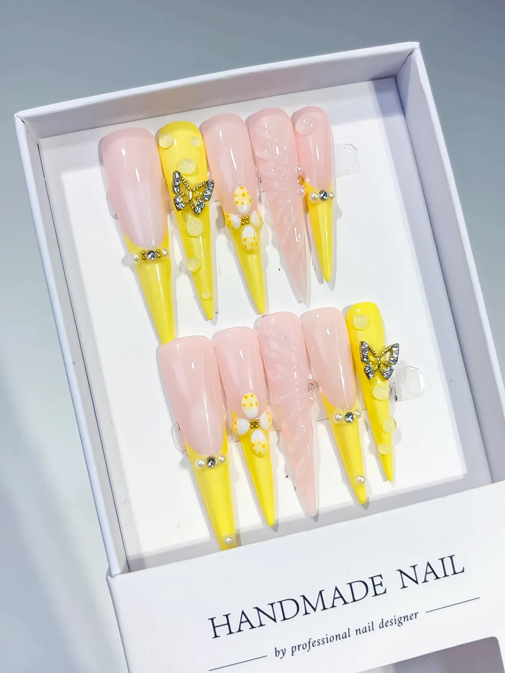 Yellow Nude White Silver French tip Flower Butterfly Rhinestone Pearl press on nails angled view