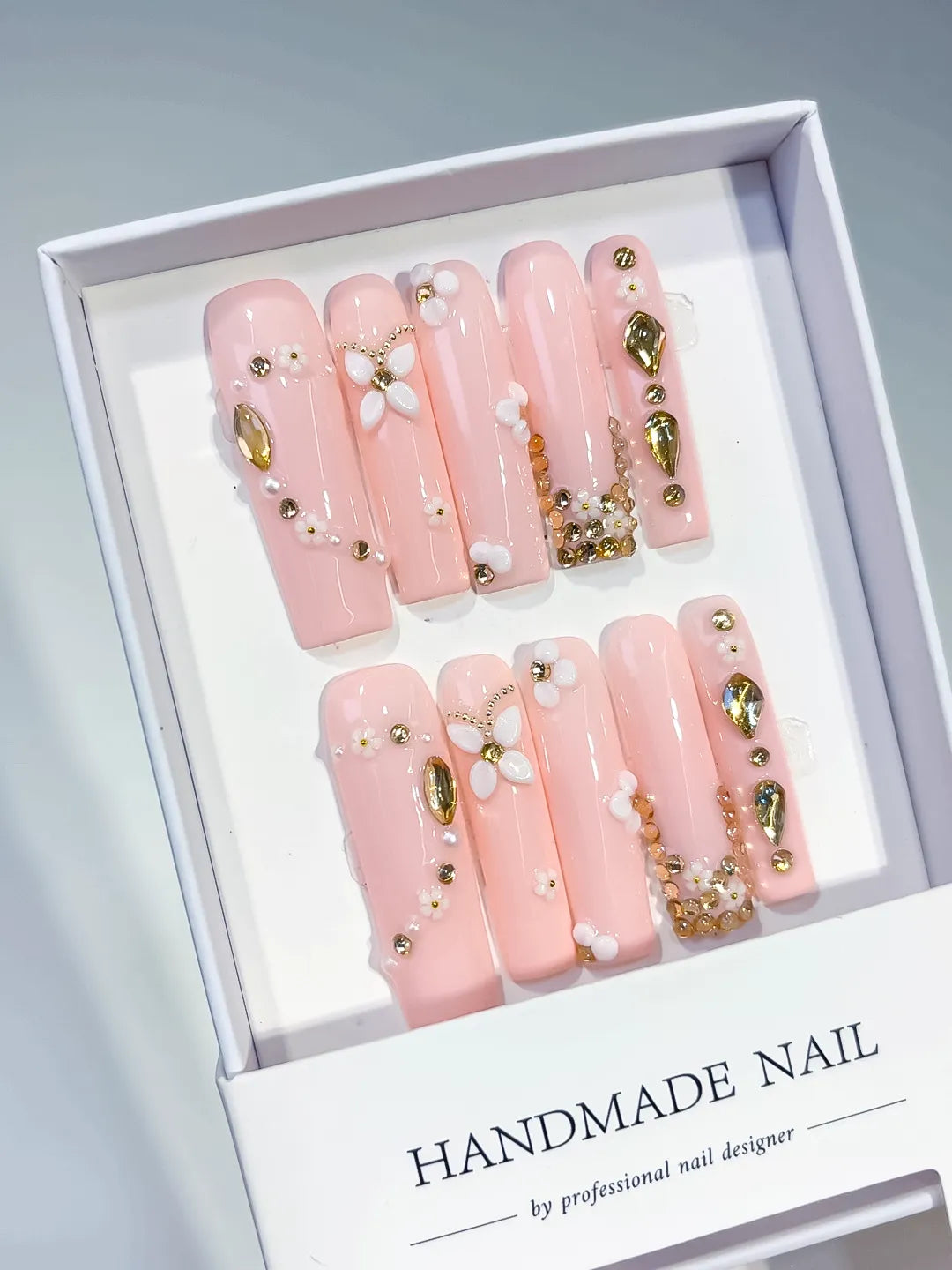 Pink Gold White Solid color Flower Pearl Chain Metallic Accent 3D press on nails angled view