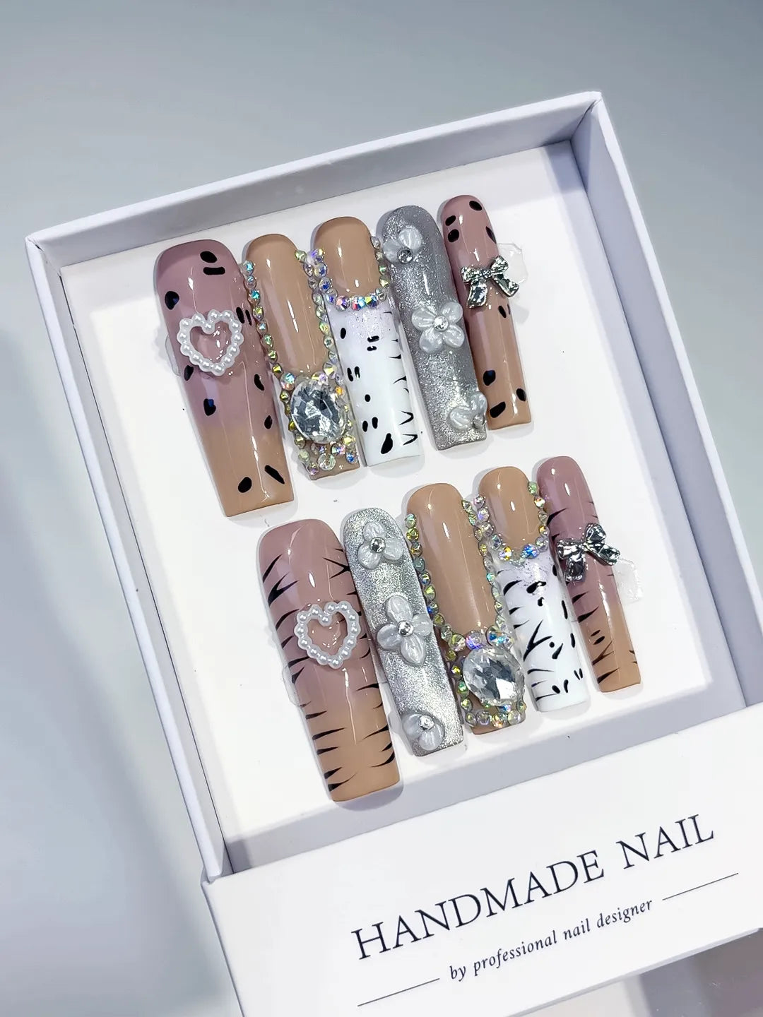 Nude White Silver Black Glitter Heart Bow Pearl Rhinestone Animal Print 3D press on nails angled view