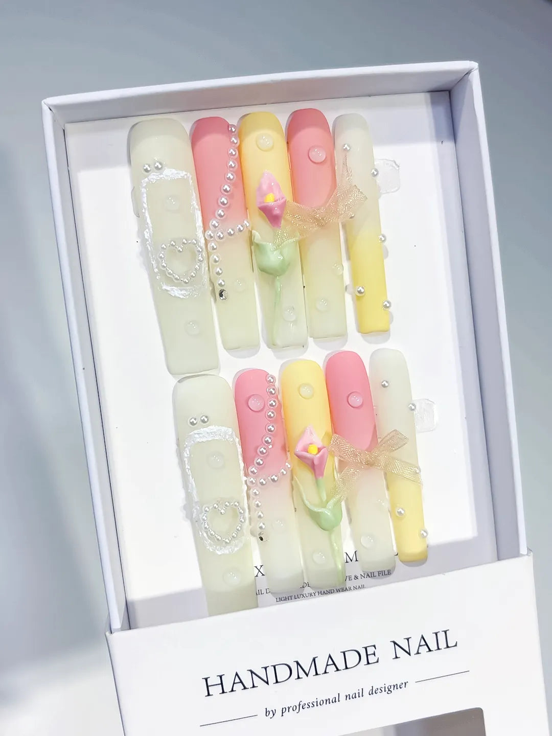 Yellow Pink White Silver Ombre Bow Heart Pearl 3D press on nails angled view
