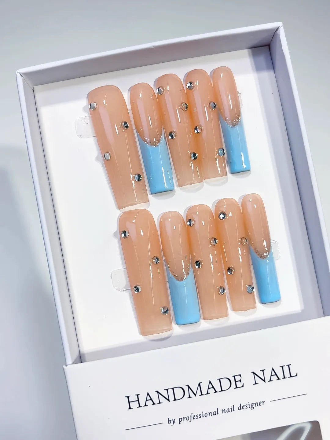 Nude Blue Silver French tip Rhinestone press on nails angled view