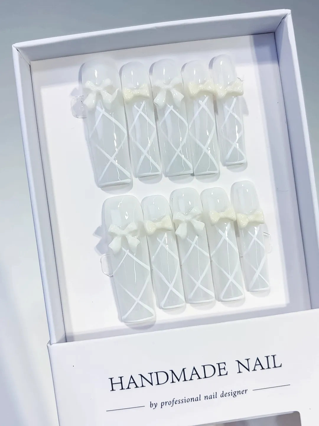 White Solid color Bow Linework 3D press on nails angled view