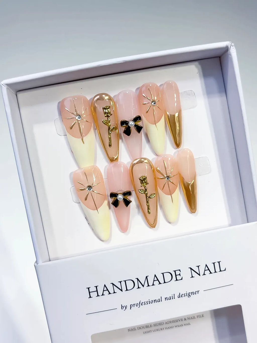 Nude White Gold Black French tip Flower Bow Rose Metallic Accent press on nails angled view