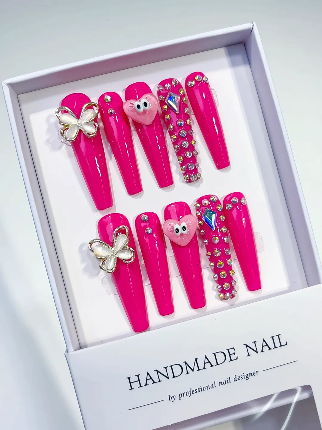 Pink Silver Solid color Heart Butterfly Rhinestone press on nails angled view