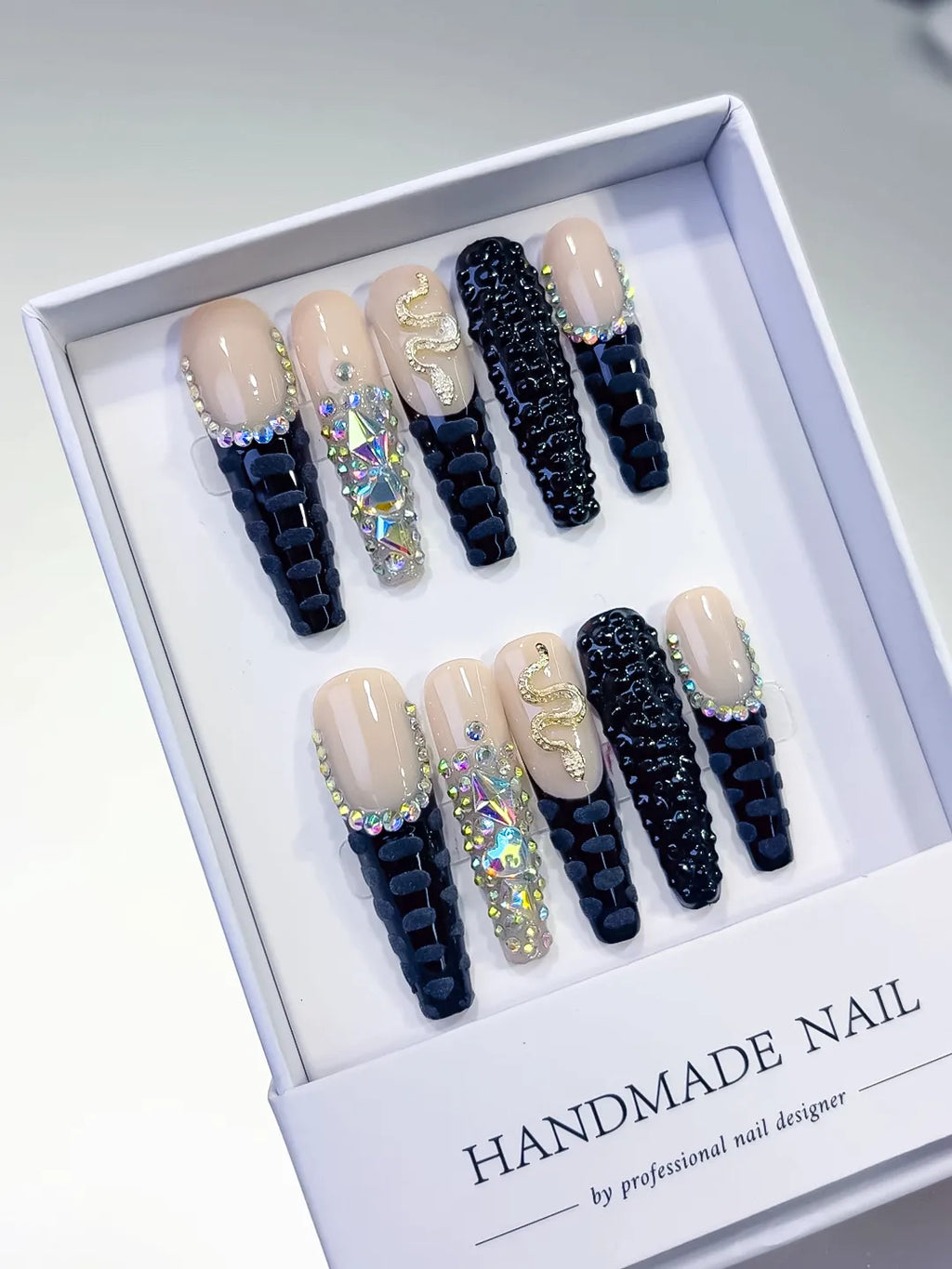 Nude Black Silver French tip Rhinestone Snake 3D press on nails angled view