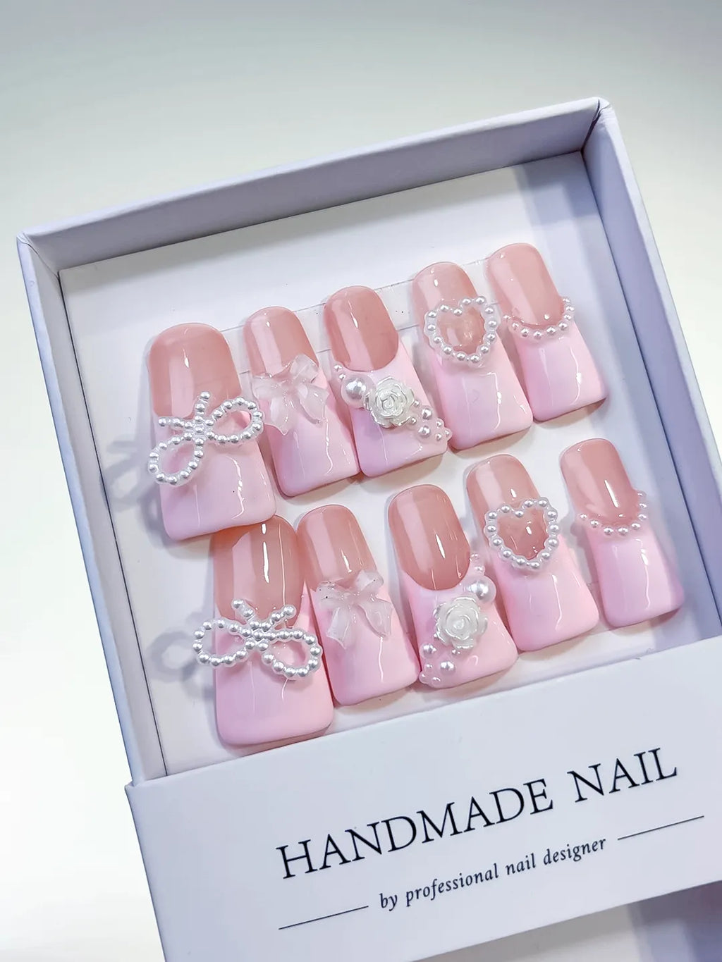 Pink Silver Solid color Bow Heart Flower press on nails angled view