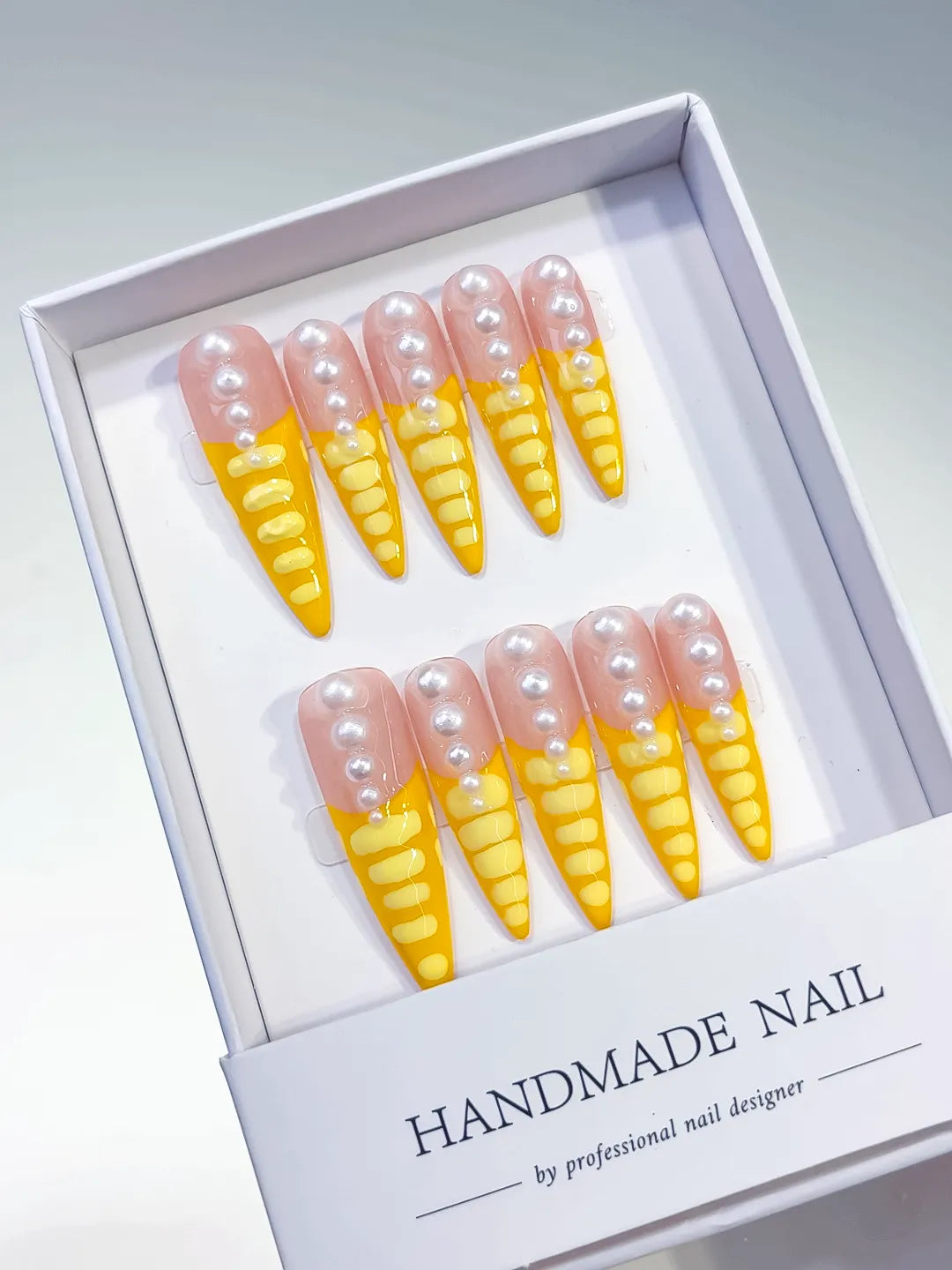 Nude Yellow White French tip Pearl press on nails angled view
