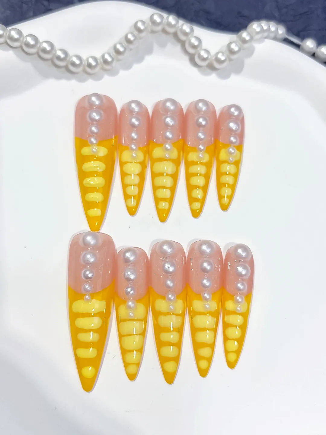Nude Yellow White French tip Pearl press on nails close up