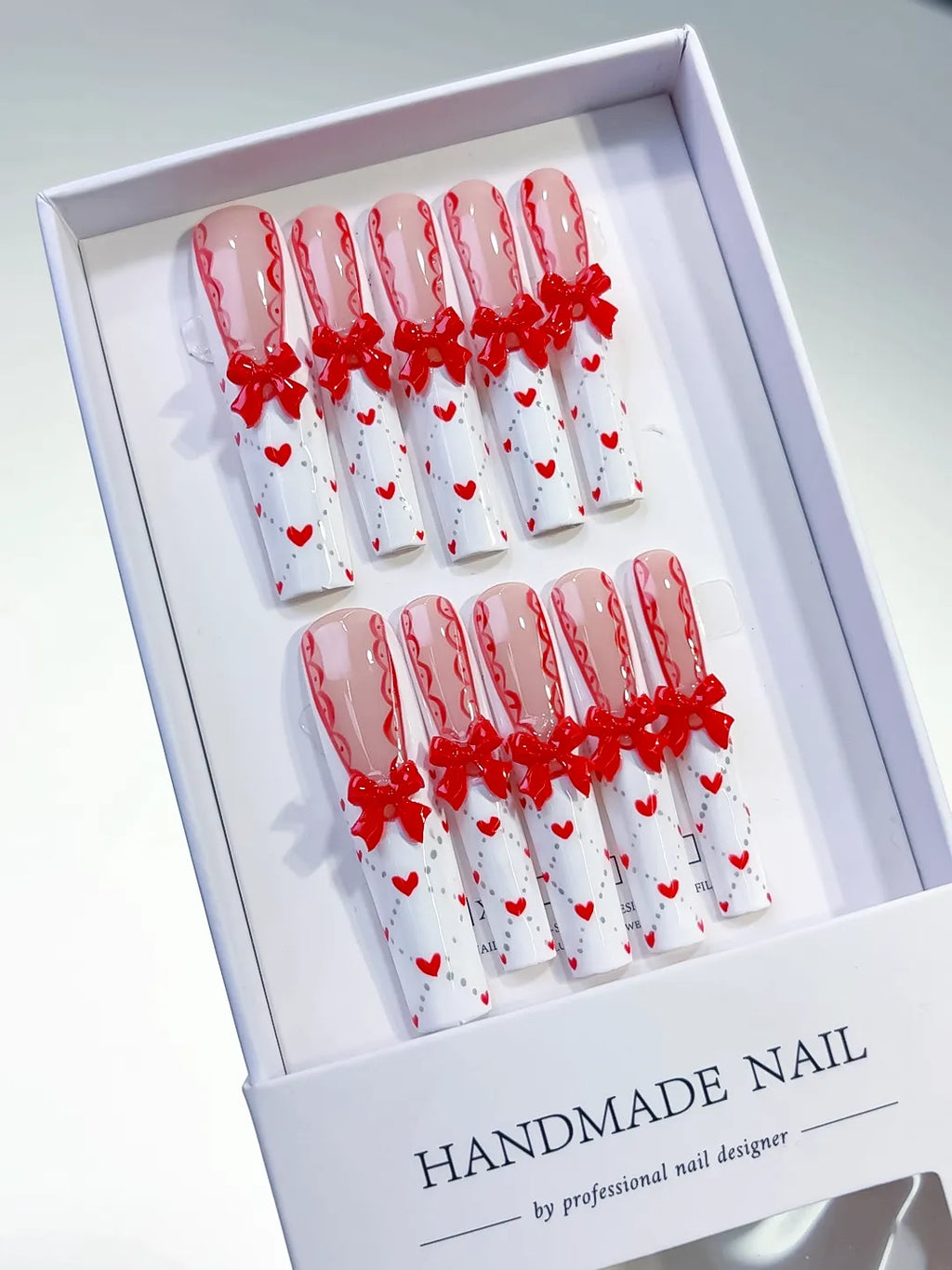 Nude White Red French tip Bow Heart 3D press on nails angled view