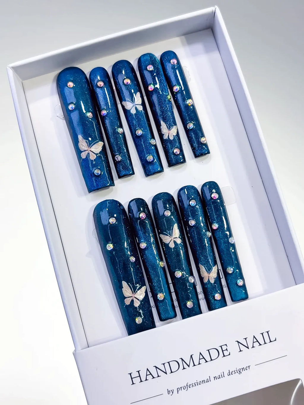 Blue Silver Metallic Butterfly Rhinestone press on nails angled view